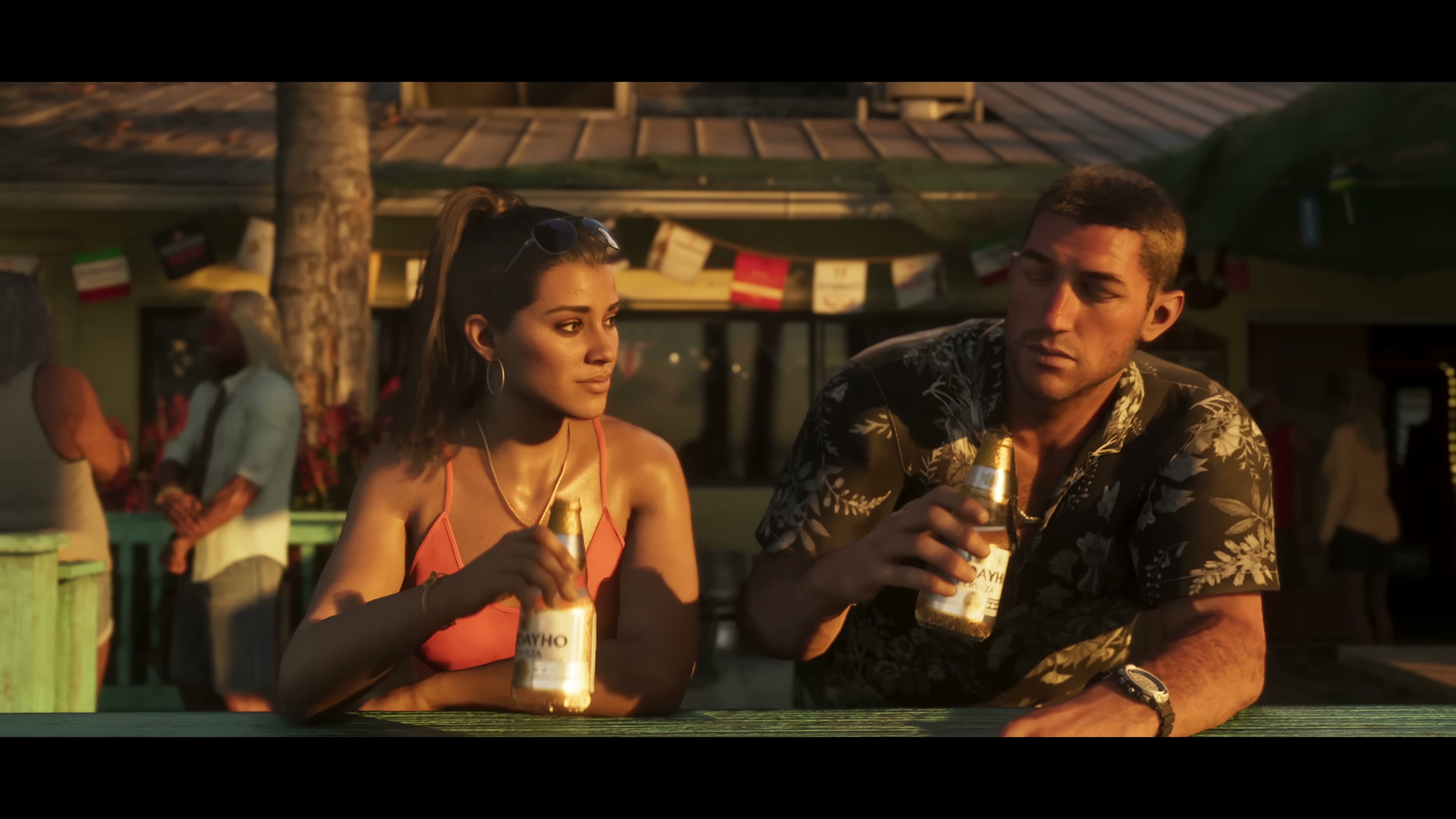Jason and Lucia drinking beer at a beachside bar at sunset