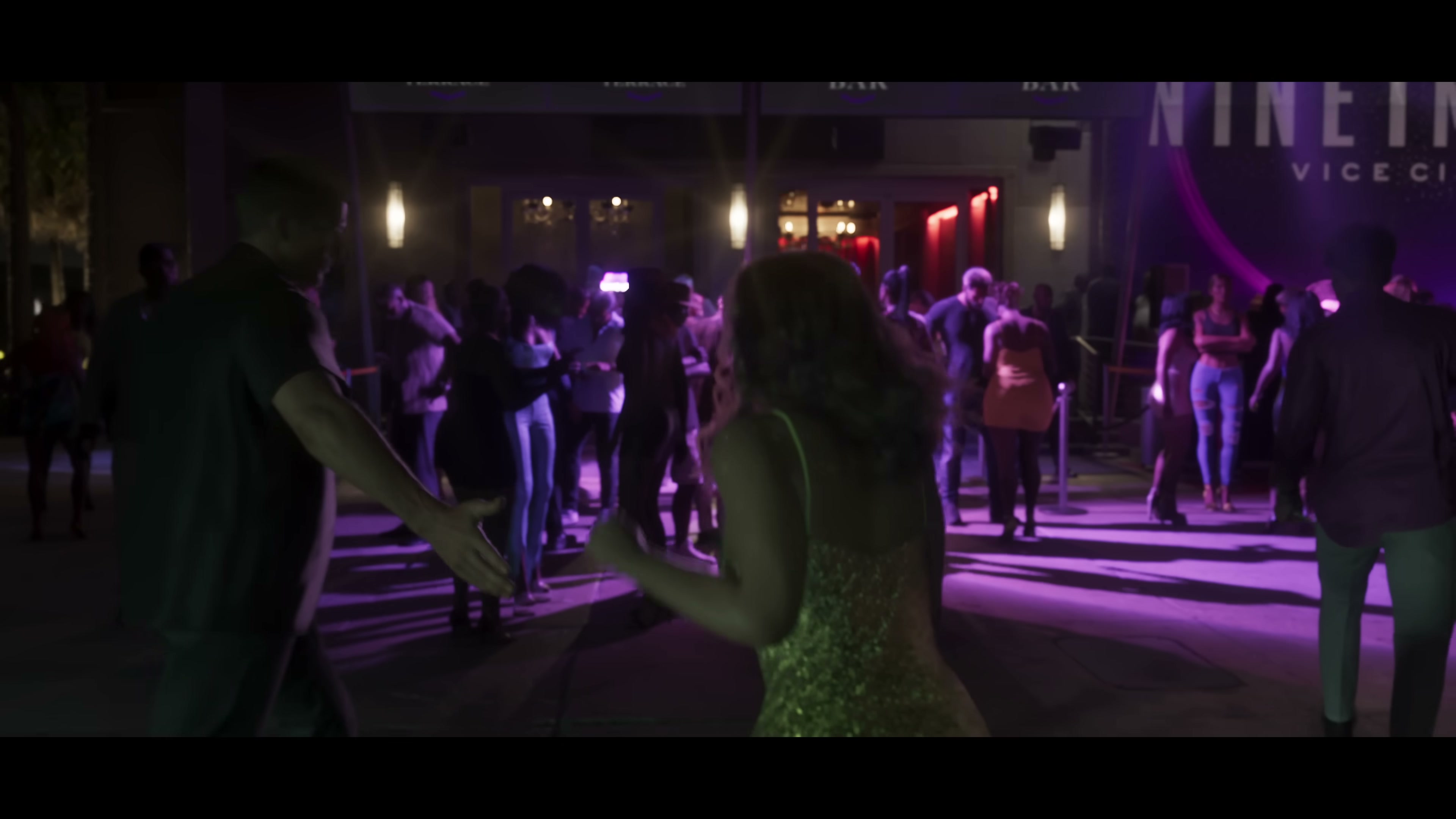 Crowded outdoor nightclub in Vice City with NINE signage and purple lighting