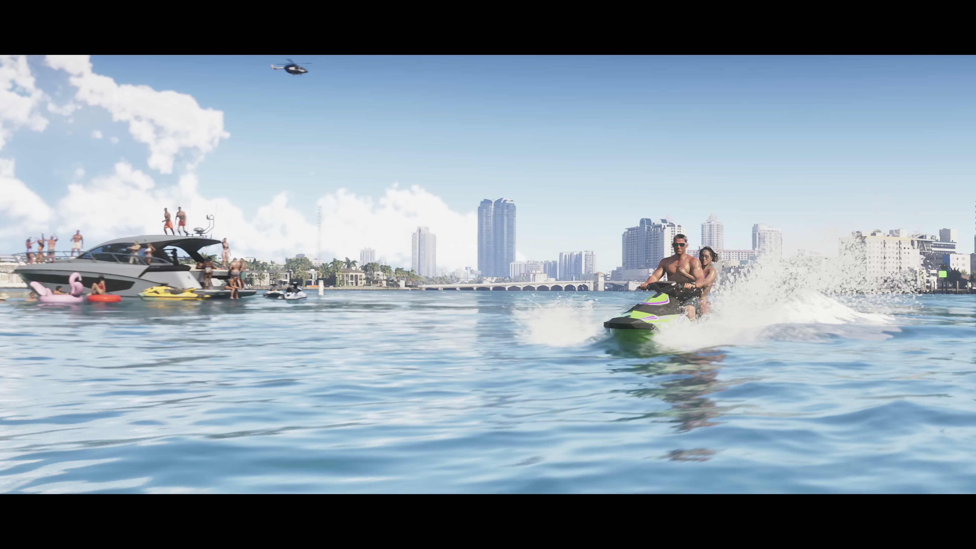 A man and woman ride a jet ski across open water with a yacht and helicopter behind them and the Vice City skyline in the distance.